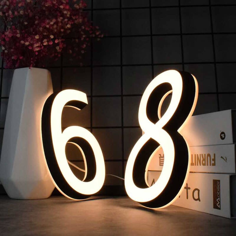 Dual-lit address plaque with numbers and family name